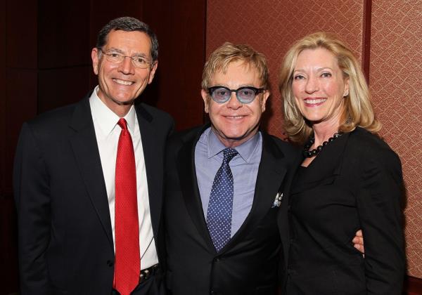 Sen. John Barrasso (R-WY), Sir Elton John, Founder, Elton John AIDS Foundation, and Bobbi Brown Barrasso pose for a photo before an Elton John AIDS Foundation and The ONE Campaign hosted reception on global HIV/AIDS funding at the U.S. Capitol Visitor Center on May 5, 2015 in Washington, DC.