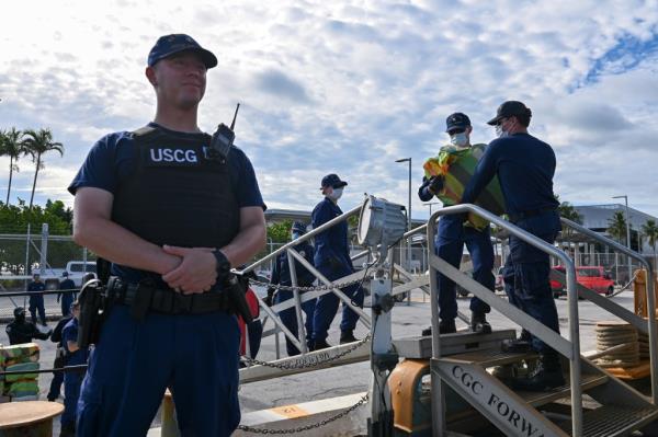 Crew members from Coast Guard Cutter Forward offload more than $96 million in illegal narcotics at Port Everglades, Florida, on Monday. 