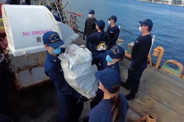 Crew members from Coast Guard Cutter Forward offload more than $96 million in illegal narcotics at Port Everglades, Florida, on Monday. 