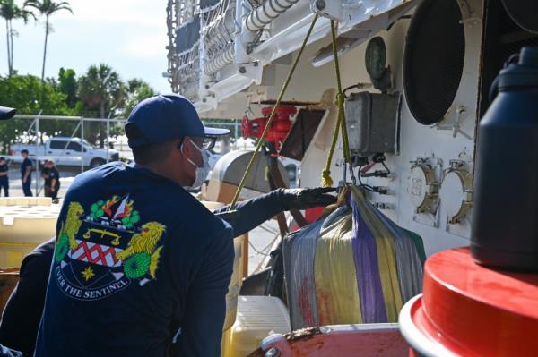 Crew members from Coast Guard Cutter Forward offload more than $96 million in illegal narcotics at Port Everglades, Florida, on Monday. 