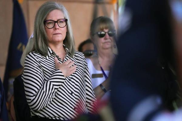 Gov. Katie Hobbs stands for the Pledge of Allegiance as people gather for a Memorial Day ceremony entitled ?￠aHome of the Brave?￠a at the VA Natio<em></em>nal Memorial Cemetery of Arizona on May 27, 2024, in Phoenix.