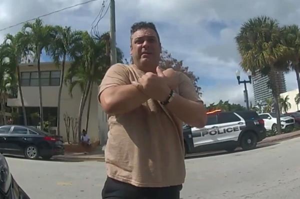Hassan Rodriquez talks to Miami police after his son was almost abducted at a CVS in February.