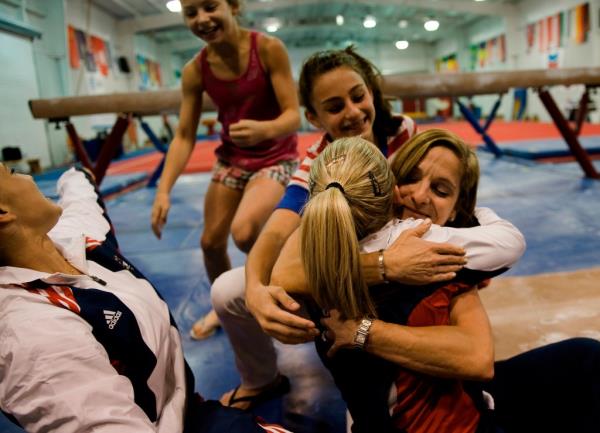 Mary Lou Retton hugs Samantha Peszek on the gym floor