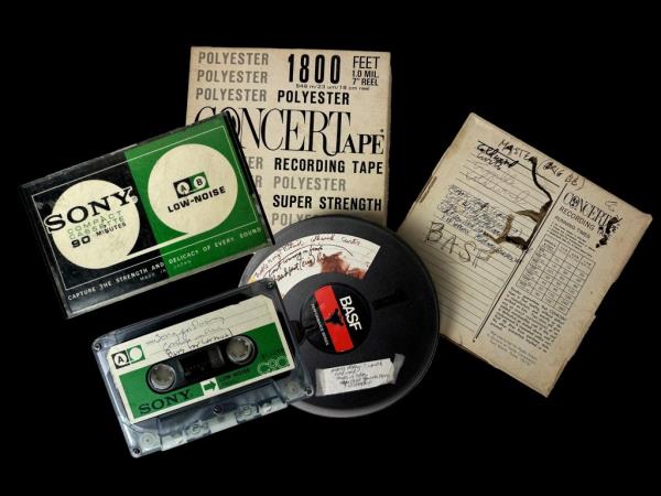 A group of cassette tapes alo<em></em>ngside a book, possibly Madonna's first recordings