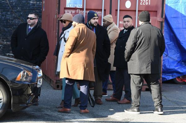 Detectives arrive to investigate the scene of the shooting.