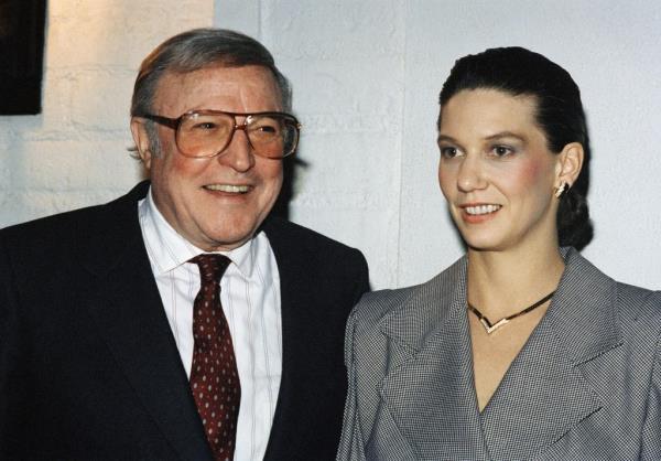 Gene Kelly leaves Chasen's Restaurant in Hollywood, California, Dec. 10, 1987, with his 