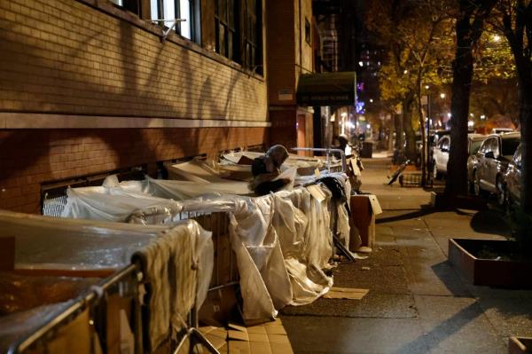 Migrants sleeping outside the former St. Brigid School in the East Village after it was turned into an intake center