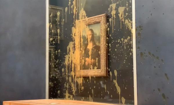 In this grab taken from video, a view of the scene after activists hurled soup at the glass protecting the Mona Lisa, at the Louvre Museum, in Paris, Sunday. Jan. 28, 2024. The two activists shouted slogans advocating for a sustainable food system. It comes as French farmers have been protesting for days across the country against several issues, including low wages.  (AP Photo/Clement Lanot)