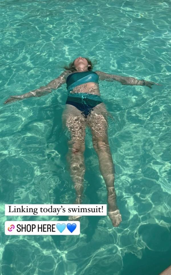 Elizabeth Smart in a blue bathing suit, floating on her back in pool, enjoying a relaxing dip during a family vacation in Palm Springs, California