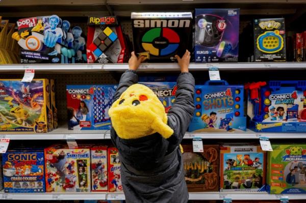 Child reaching for toy on shelf in Target.