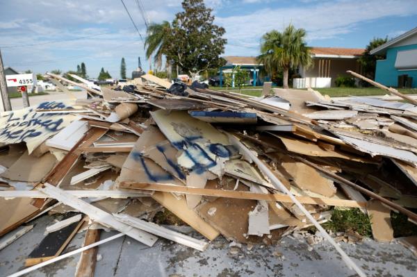 Debris from Hurricane Helene sits on the roadside as residents evacuate before the arrival of Hurricane Milton, in New Port Richey, Florida, U.S.