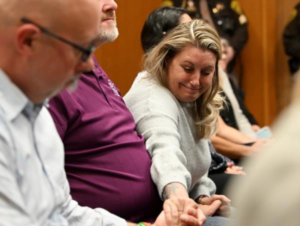 Nicole Beausoleil sitting next to other victim family members.
