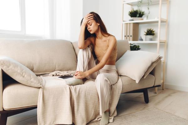 Lo<em></em>nely Woman on the Couch: A Depressed Girl Co<em></em>ntemplating Health Problems in a Sad.