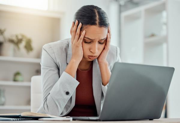 Pain, headache and stressed finance manager feeling sick, tired and worried a<em></em>bout a financial problem at her startup company. 