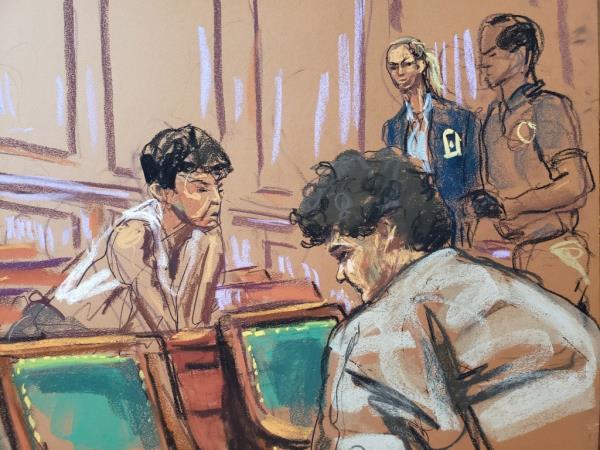 Sam Bankman-Fried speaks to his mother, Barbara Fried, across the low partition between the courtroom well and the galley after a hearing on Tuesday.