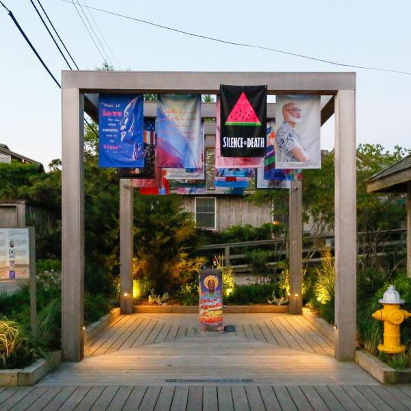 Members of ACT UP NY raising two flags in ho<em></em>nor of Cecilia Gentili and Queer Palestinians at Fire Island's Trailblazers Park