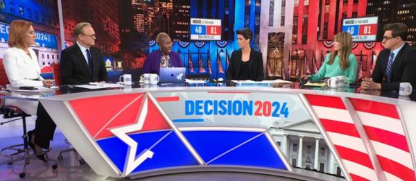 MSNBC anchors sitting around the desk on election night.