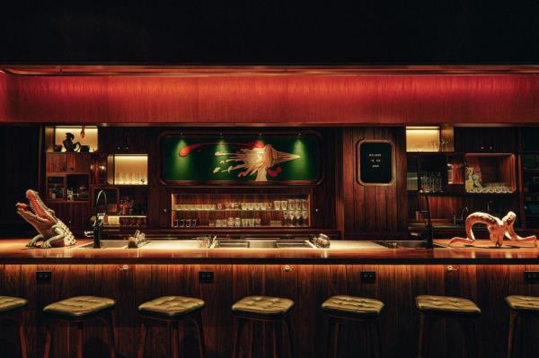 Luxurious interior of Martiny's bar in New York, showcasing Japanese precision techniques led by Takuma Watanabe, seen pouring a drink into a martini glass
