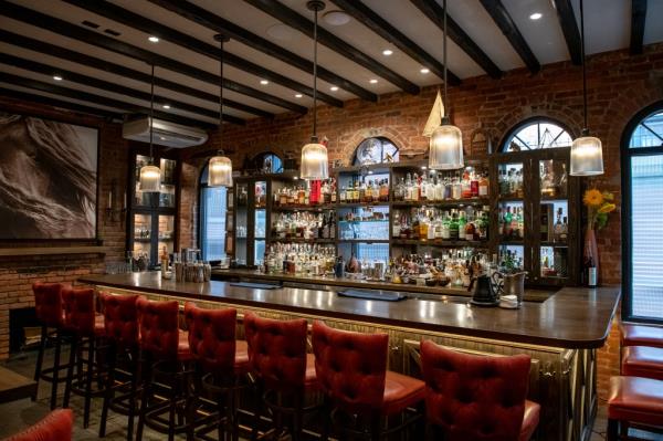 Interior of Martiny's luxury bar in New York City, showcasing a row of chairs and an array of bottles, reflecting Japanese precision in its setup.