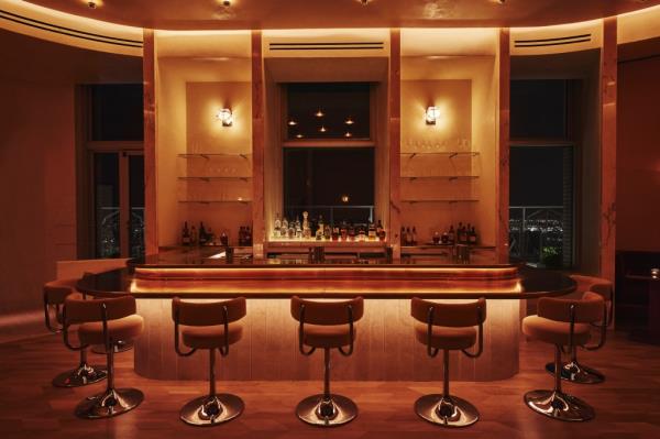 Aerial view of Overstory bar located on the 64th floor of a skyscraper in New York's financial district with city's skyline in the background