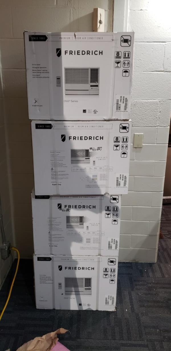 New air co<em></em>nditioners stacked up, still in their boxes.