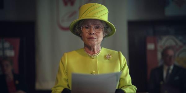 Imelda Staunton as Queen Elizabeth II smiling in a yellow hat. 