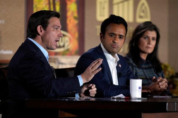 Republican presidential candidate Florida Gov. Ron DeSantis speaks during the Family Leader's Thanksgiving Family Forum as Republican presidential candidate businessman Vivek Ramaswamy, center, and Republican presidential candidate former U.N. Ambassador Nikki Haley, right, watch, Friday, Nov. 17, 2023, in Des Moines, Iowa. 