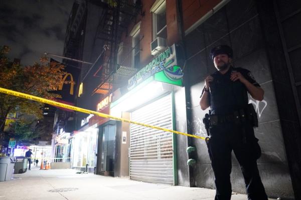 A police officer stands watch over the spot wher<em></em>e the attack happened.