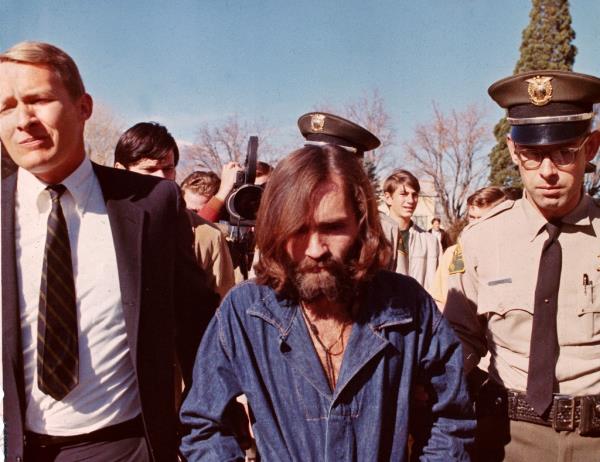 Charles Manson is escorted on his way back to jail after court arraignment in Los Angeles on Dec. 22, 1969.