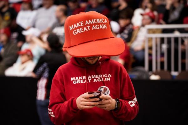 A supporter of U.S. President Do<em></em>nald Trump wears an oversize