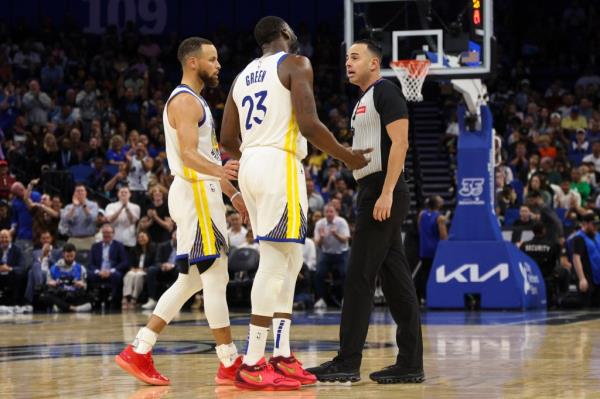 Golden State Warriors forward Draymond Green (23) talks to referee Ray Acosta (54) after a foul call in the first quarter at the Kia Center in  Orlando, Florida on March 27, 2024.