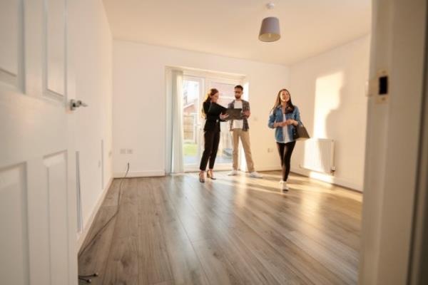 Estate agent shows potential buyers around a property