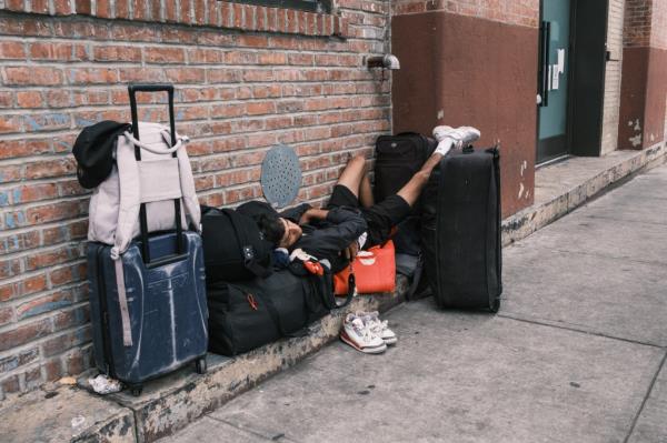 A migrant sleeps on Ryerson Street.