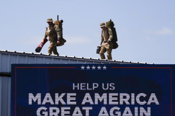 Security gets into position prior to Republican presidential nominee former president Do<em></em>nald Trump speaks at a rally in Asheboro, North Carolina. 