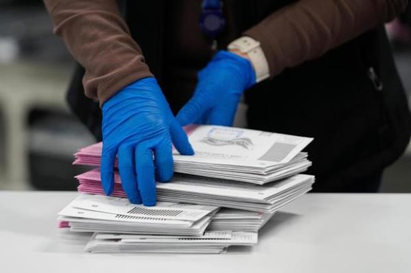 An election worker sorts mail-in ballots at the Washoe County Registrar of Voters office