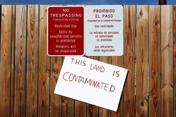 Signs are posted on a fence surrounding the failed tent encampment for migrants at the northwest corner of California Avenue and 38th Street in Chicago's Brighton Park neighborhood on Nov. 28, 2023.