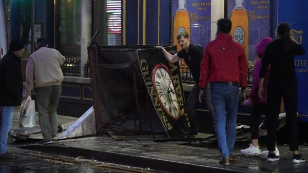 A clock tower falls to the ground in Eyre Square, Galway