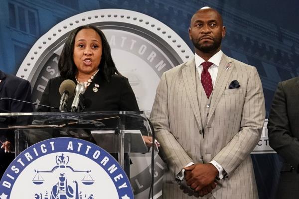 Fulton County District Attorney Fani Willis speaks at a press co<em></em>nference next to prosecutor Nathan Wade after a Grand Jury brought back indictments against former president Do<em></em>nald Trump and his allies in their attempt to overturn the state's 2020 election results, in Atlanta, Georgia, U.S. August 14, 2023. 
