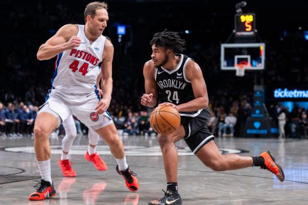 Nets guard Cam Thomas (24) drives around Detroit Pistons forward Bojan Bogdanovic