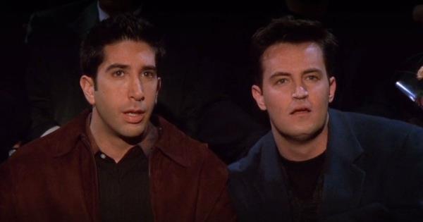 David Schwimmer as Ross and Matthew Perry as Chandler in Friends' The One With Rachel's Crush wearing a red and blue jacket, looking at something off-screen.