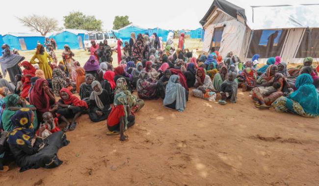 Women who fled the war in Sudan await the distribution of internatio<em></em>nal aid rations at the Ourang refugee camp, near Adre town in eastern Chad on August 15, 2023. (AFP)