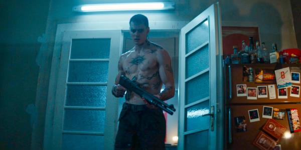 Eric (Bill Skarsg?rd) carrying a shotgun in The Crow (2024) 