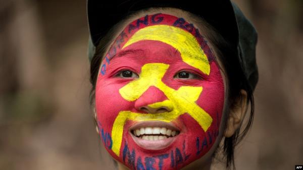 FILE - Ka Kathryn, a 25-year-old from a middle-class family, who is a guerrilla of the New People's Army, is seen in the Sierra Madre mountain range, east of Manila, on July 30, 2017. 
