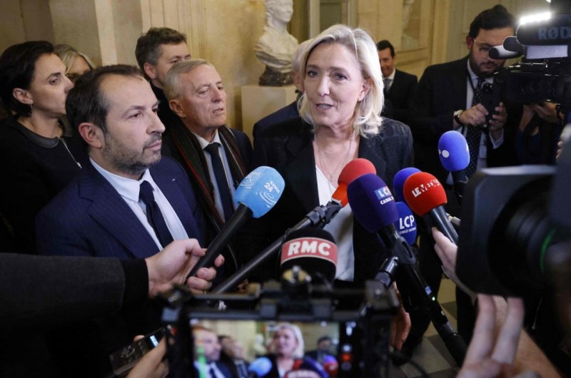 French Member of Parliament and President of the ‘Rassemblement National’ (RN) group Marine Le Pen answers journalists next to MP Sebastien Chenu (L) after a debate on the draft law to co<em></em>ntrol immigration at the Natio<em></em>nal Assembly in Paris on Dec. 11, 2023. (AFP Photo)
