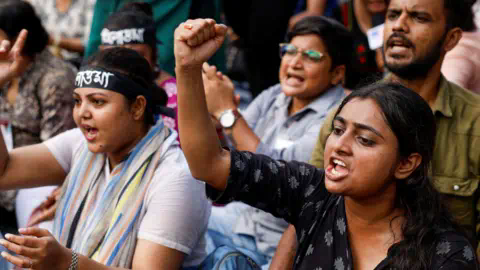 Getty Images Medics sit and chant slogans as they attend a protest co<em></em>ndemning the rape and murder of a trainee medic at a government-run hospital, in Kolkata, India, September 10, 2024.
