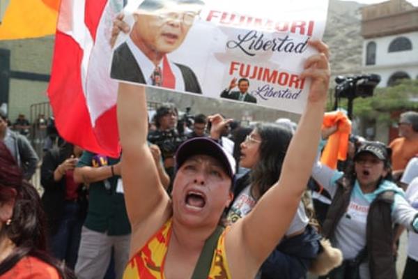 Supporters of former president Alberto Fujimori await outside Penal Barbadillo for his release on Wednesday in Lima, Peru.