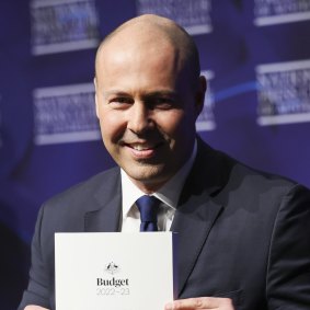 Then-treasurer Josh Frydenberg poses for photos with budget docu<em></em>ments in 2022.