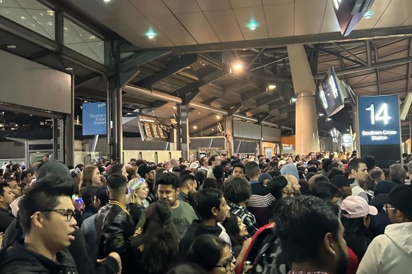 Commuters wait to get o<em></em>nto train platforms at Southern Cross Station in the first hours of 2024.
