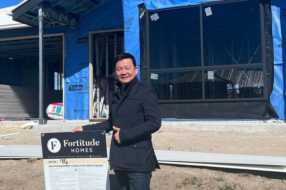 Yong poses outside a house under co<em></em>nstruction in July this year. 