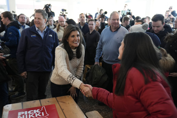 Republican presidential candidate former ambassador to the UN Nikki Haley shakes hands with a diner at the Beach Plum in New Hampshire on Sunday.